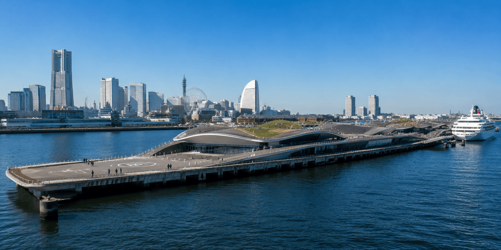 Osanbashi Pier's undulating wooden rooftop deck with the Minato Mirai skyline and Yokohama Harbor in the background